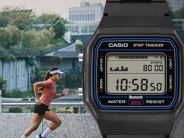 Casio F-B100W digital watch displaying the time on its LCD screen with blue dial accents.