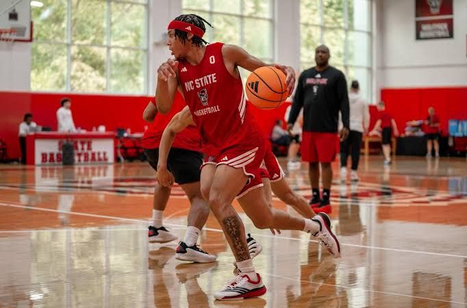 NC State guard Preston Edmead dribbling down the court during a team practice session.