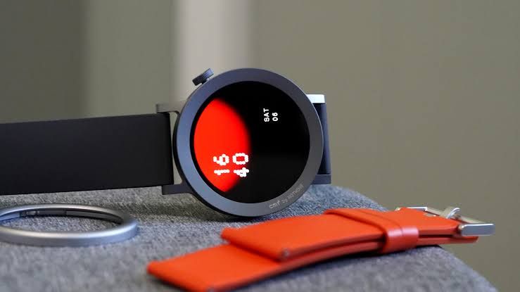 CMF Watch Pro 2 resting on its side showing the native watch face display on an AMOLED screen.