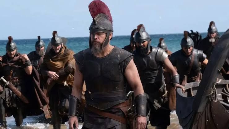 Christopher Nolan's film The Odyssey poster featuring lead cast members against a cinematic background.