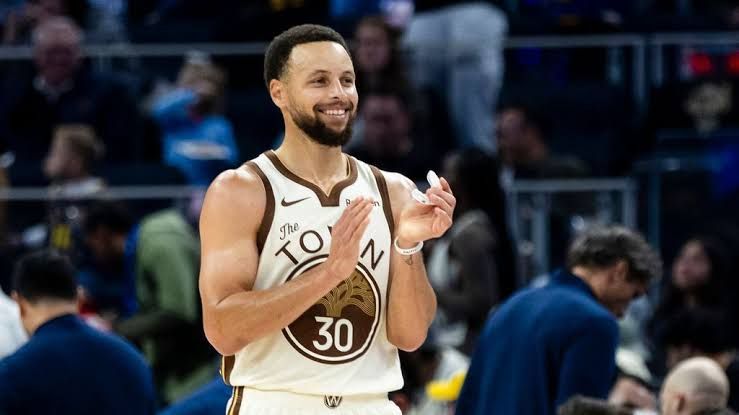 Stephen Curry standing on an NBA court during a game for the Golden State Warriors.