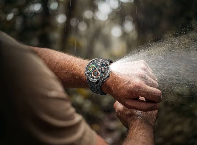 The Rogbid SpinR rugged smartwatch with a black frame and orange strap displayed on a white background.