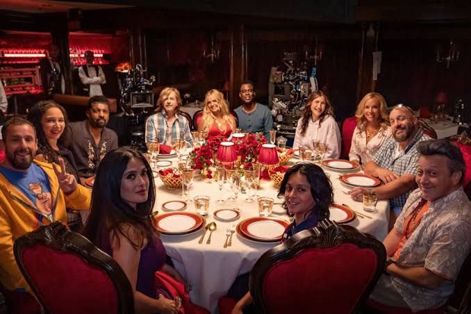 Adam Sandler and the main cast of Grown Ups 3 sitting around a table during production in New Jersey.