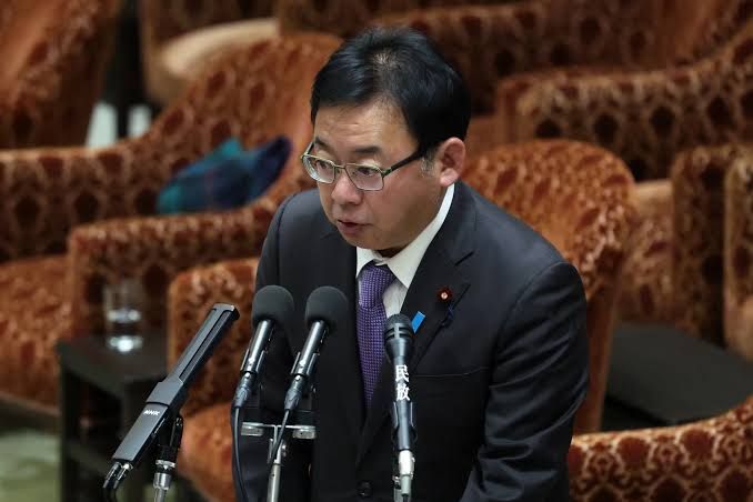 Health Minister Kenichiro Ueno at a press conference in Tokyo discussing government pension fund strategy.