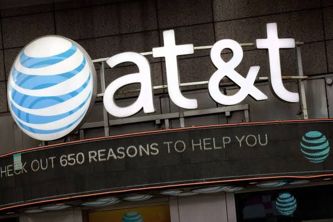 An AT&T logo sign positioned above a storefront, representing the ongoing internet service outages in Texas.