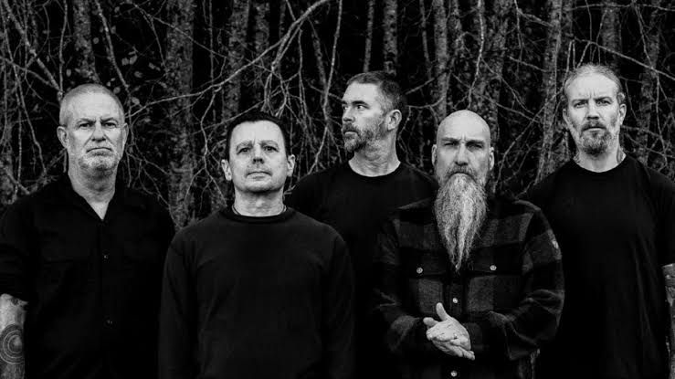 Neurosis performing live on stage with heavy lighting and shadow in a concert venue setting.