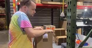 Jack Hartley assembling shipping boxes at the Grandpa Joe's warehouse as part of a vocational training program.
