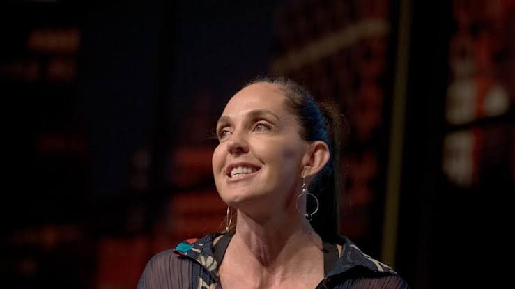 Janine Allis speaking at a conference regarding her business ventures and family management strategies.
