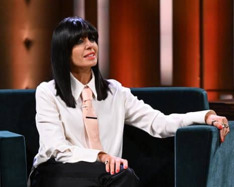 Claudia Winkleman sitting on a sofa during the filming of her chat show at the BBC studios.