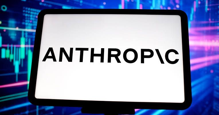 Close up of an Anthropic logo displayed on a digital screen near a server rack in a secure data center.
