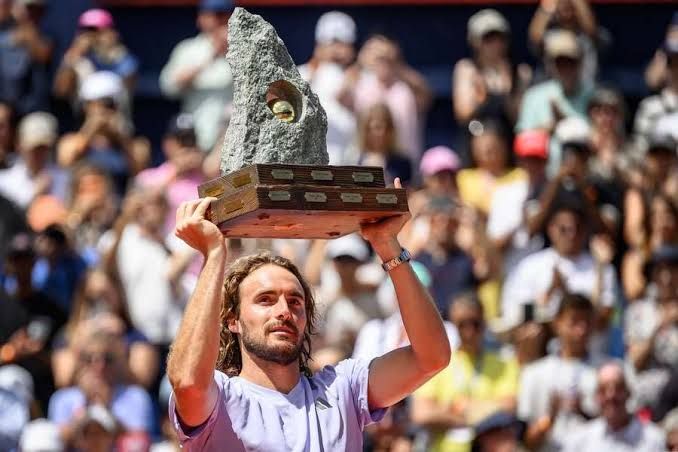 Stefanos Tsitsipas holding the Swiss Open trophy after defeating Raphael Collignon in Gstaad.
