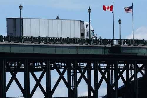 A Canadian flag flying alongside an American flag, representing the recent tariff dispute.
