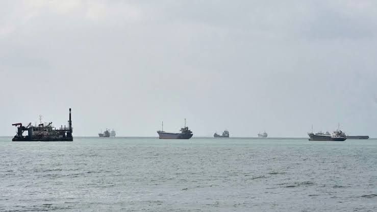 Commercial vessels anchored in the Strait of Hormuz near Bandar Abbas, Iran, amid escalating regional military tensions.