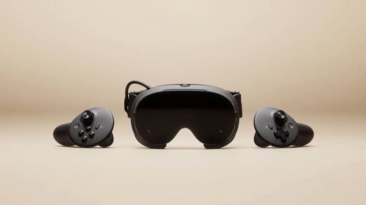 Valve Steam Frame VR headset shown with handheld controllers in a studio setting.