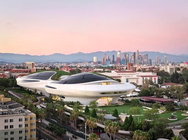 The main plaza and curved, floating facade of the Lucas Museum of Narrative Art in Los Angeles.