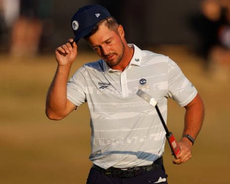 Bryson DeChambeau waves to spectators after concluding his round on the 18th hole at Royal Birkdale.