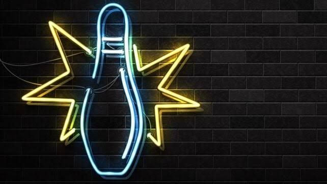 Close-up of a neon-20 atomic nucleus modeled with a bowling pin shape against a dark particle collision background.