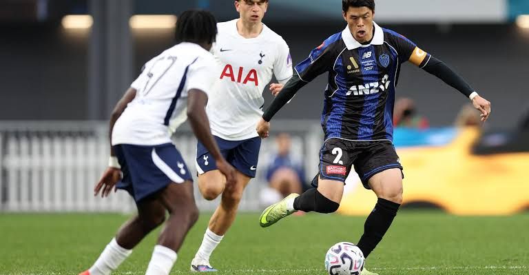 Archie Gray wearing the Tottenham Hotspur captain's armband while controlling the ball during the match in Auckland.