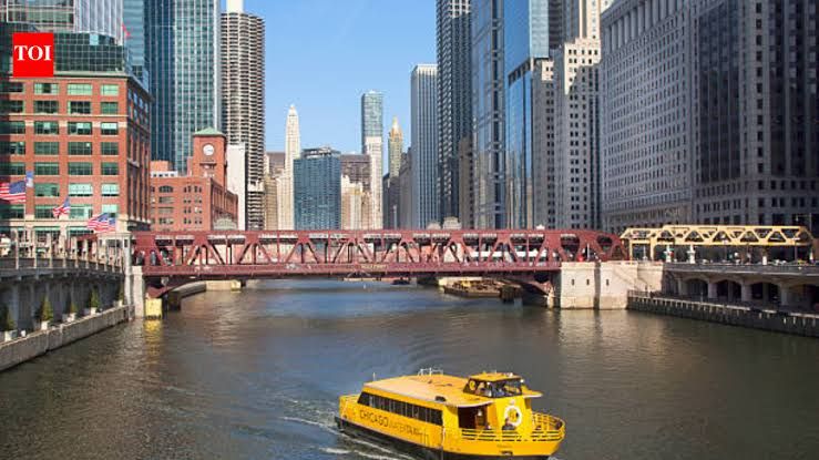 The Chicago River flowing through downtown Chicago with the city skyline visible in the background.