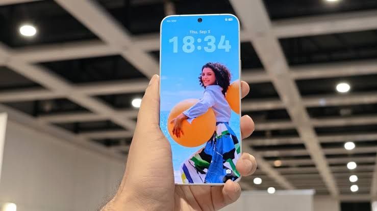 Tecno Next-Gen Bezelless Concept phone screen lit up in a user's hand at IFA Berlin.