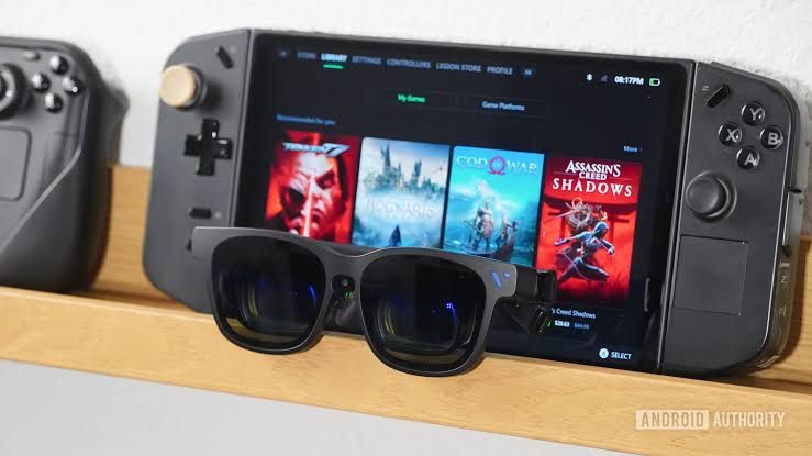 VITURE Beast XR glasses connected via USB-C to a Lenovo Legion Go handheld gaming device on a desk.