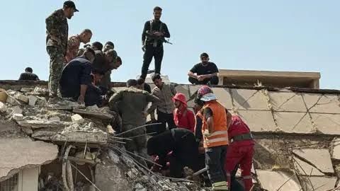 Iraqi emergency crews work at a bomb site in Diyala province following US and Saudi air strikes.