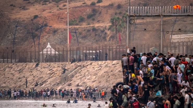 Italian flag flying near a maritime border checkpoint during the Ceuta migration crisis in July 2026.