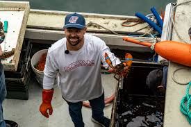 Ricky Stenhouse Jr. holding a lobster at Luke’s Lobster Portland Pier during his visit to Maine.