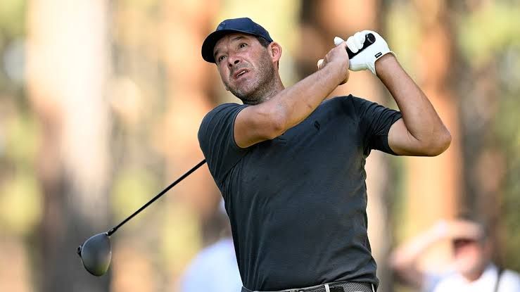 Tony Romo on the golf course preparing to strike a ball during the American Century Championship tournament.