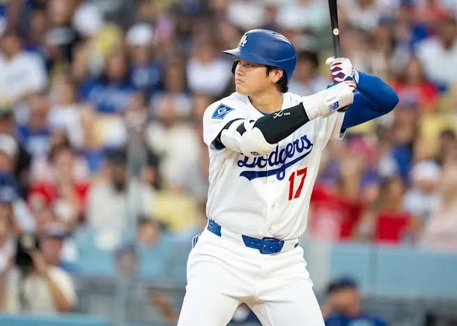Shohei Ohtani in a Dodgers uniform standing at home plate during a game at Dodger Stadium in September 2026.