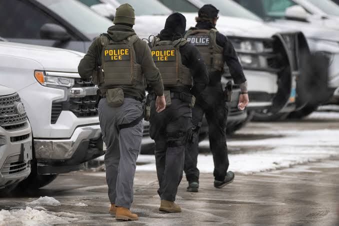 ICE agents walking through a parking lot during a 2025 enforcement operation in Minneapolis.