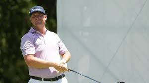 Trey Mullinax standing on a professional golf course during a PGA Tour event.