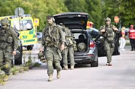 Police and emergency vehicles outside Brinell School in Fagersta, Sweden, following a fatal sword attack.
