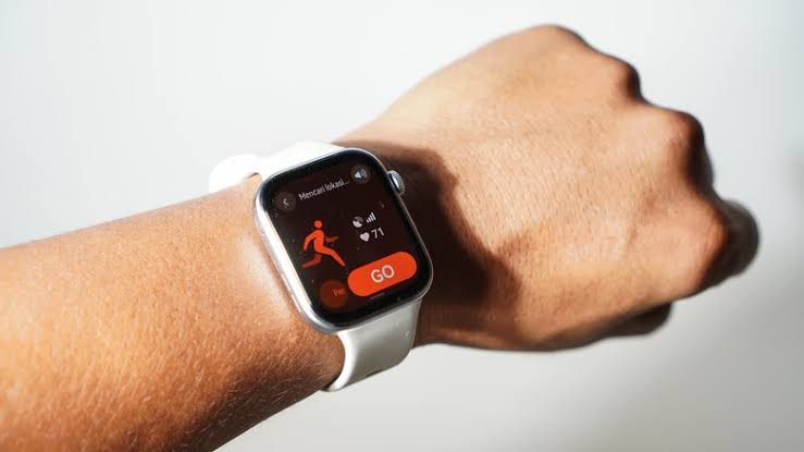 Close up of a person wearing a sleek rectangular Huawei smartwatch with an active AMOLED screen.