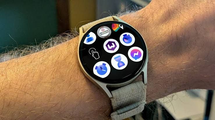 Close-up of a Samsung Galaxy Watch 7 displaying various application icons on the touchscreen interface.