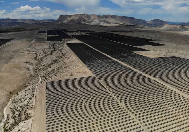 Solar power arrays in a field in Emery, Utah, representing the state of the renewable energy sector.