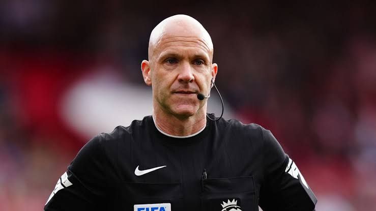 Referee Anthony Taylor gesturing during a match in the Premier League.