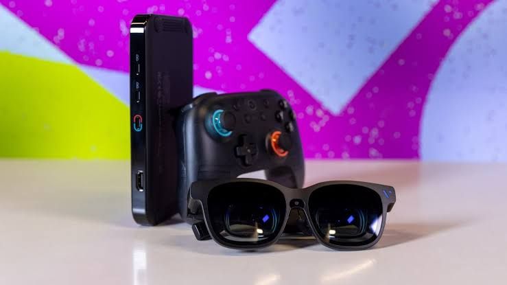 Viture Beast XR glasses displayed next to gaming equipment, showcasing the hardware's 174-inch virtual display capabilities.
