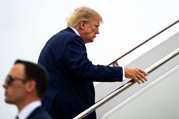 Donald Trump walks across the deck of the USS Abraham Lincoln during a campaign visit to discuss naval policy.