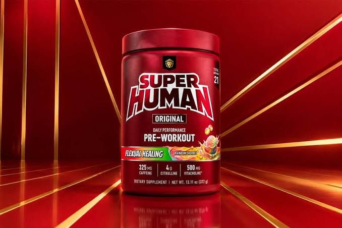 A container of Alpha Lion Superhuman Original pre-workout sitting on a surface next to brand marketing materials.