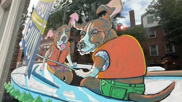 A colorful beagle-themed mural on the window of the Gulu-Gulu Café in Salem, Massachusetts.