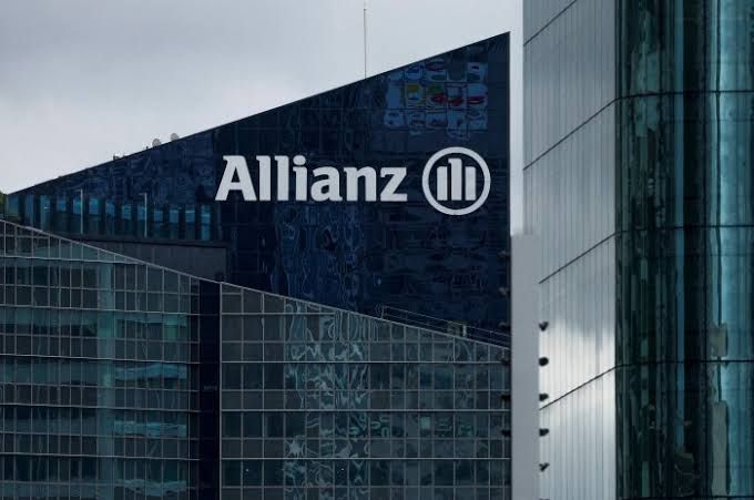 Allianz corporate headquarters exterior in Munich displaying the company logo against a clear sky during business hours.