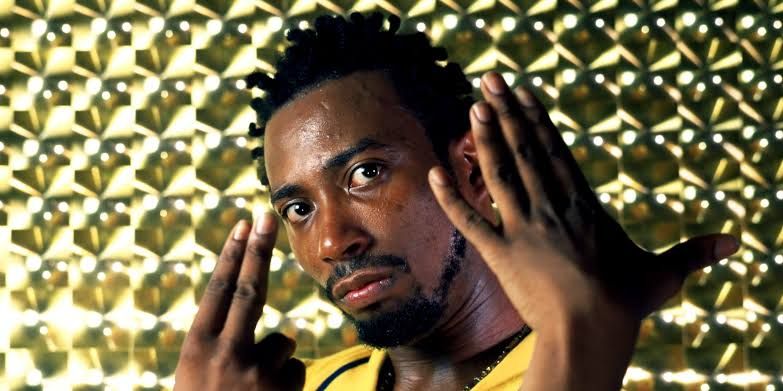 Close-up portrait of rapper Ol’ Dirty Bastard with black hair looking at the camera.