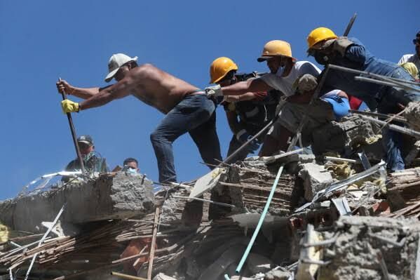 Soldiers clearing debris from the streets of Cali, Colombia, three days after the 7.4 magnitude earthquake.
