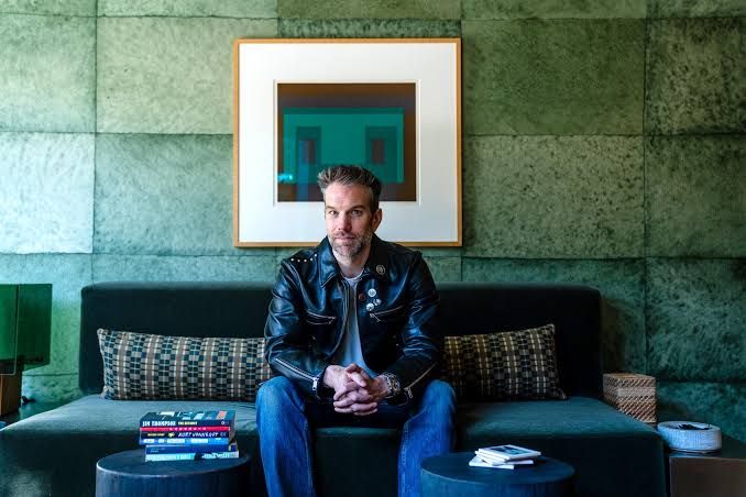 Anthony Jeselnik holding a book while speaking during a session about his new literary project in Los Angeles.