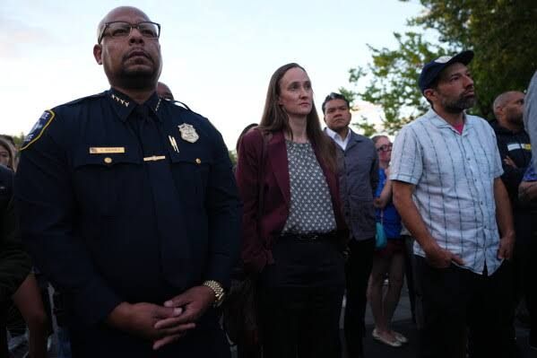 Mayor Katie Wilson and Police Chief Shon Barnes attending a vigil at Seattle Center after the food festival shooting.