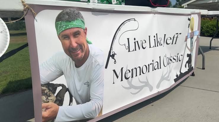 Golf course green with memorial signage honoring a fallen Consumers Energy lineman in Ottawa County.