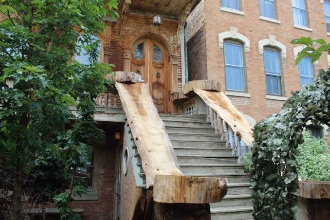 Exterior view of the historic Wacker House in Chicago showing altered staircases and missing siding.