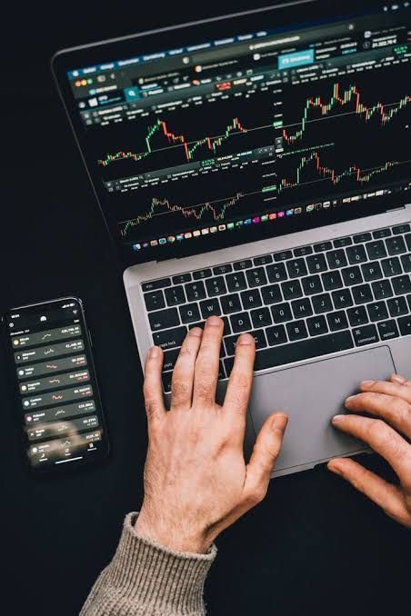 An investor checking stock market trends on a laptop screen as part of a retirement savings strategy.