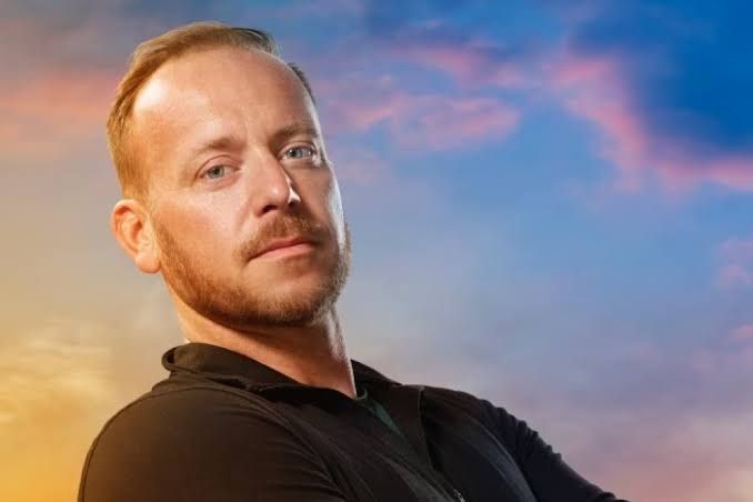 Tyler Duckworth posing for a professional headshot while filming for The Challenge competition series on MTV.